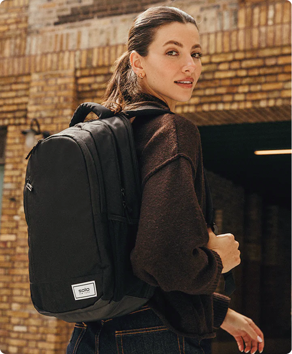 A Solo New York backpack worn on a city street